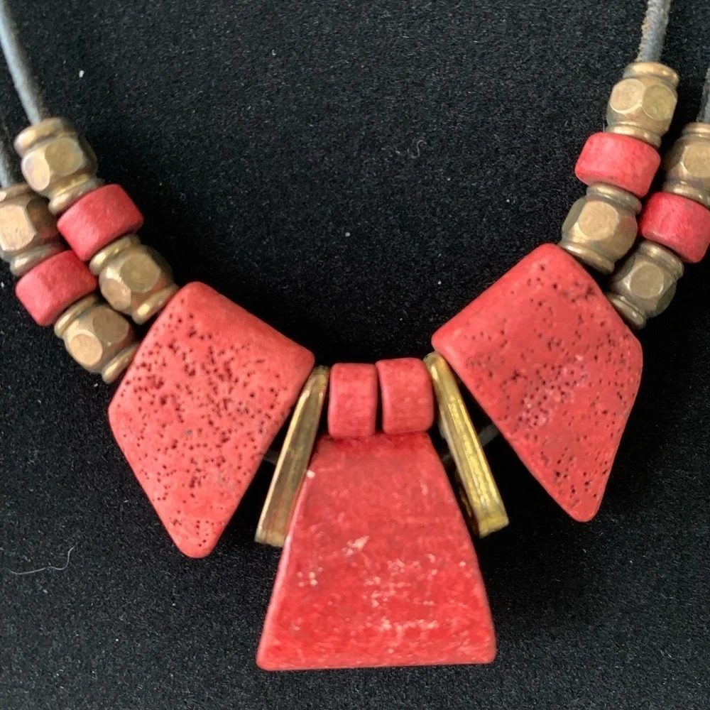Vintage coral and gold‎ colored beaded necklace on a leather chain.